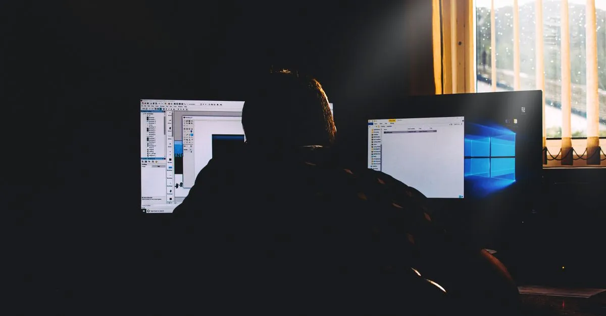 Software engineer writing a Dockerfile and building container images on a laptop