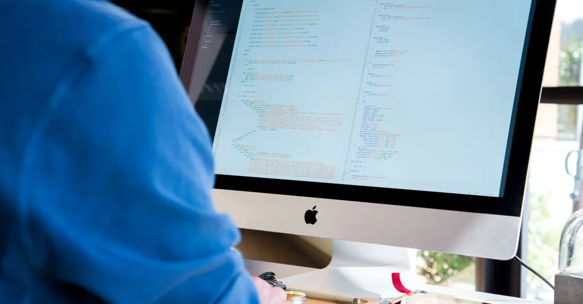 Operations engineer reviewing infrastructure monitoring dashboards on multiple screens